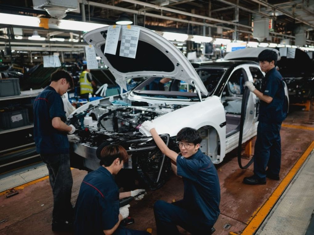 Workers at Chinese EV assembly line